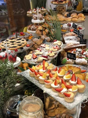 a buffet of different types of desserts and pastries at Erbavoglio Hotel in Rimini