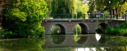 a bridge with two arches over a river at HARBOR HOUSE ZEELAND - nl in Goes