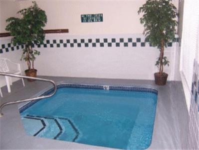 a swimming pool in a room with two plants at Hospitality Inn in Portland