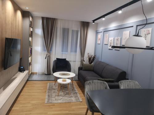 a living room with a couch and a table at MM Kolasin Lux N1 in Kolašin