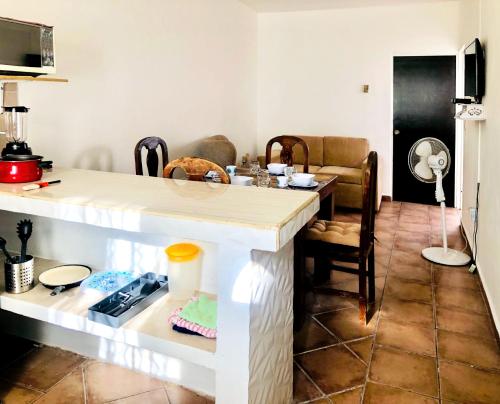 a kitchen with a counter and a table with chairs at Casa Angeles in Nuevo Vallarta 