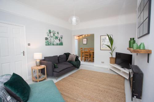 a living room with a couch and a tv at Foresters Cottage in Worthing