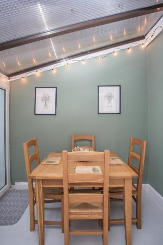 a dining room with a wooden table and chairs at Foresters Cottage in Worthing