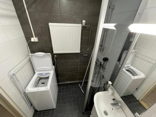 a bathroom with a toilet and a sink at Holiday Home Sodankylä in Sodankylä