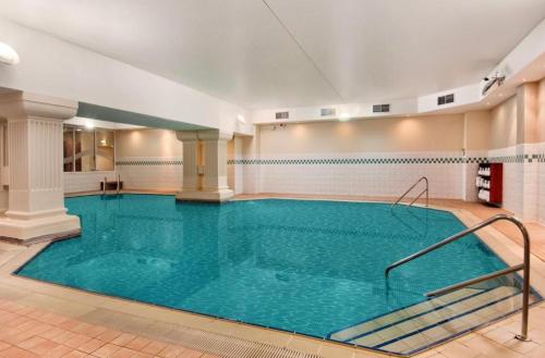 a large indoor swimming pool with blue water at Luxury Beachfront Apartment Brighton Centre in Brighton & Hove