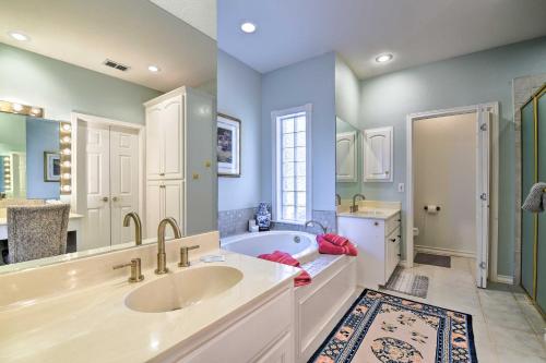 a bathroom with two sinks and a bath tub at Abilene Home with Backyard and Grill Walk to ACU in Abilene