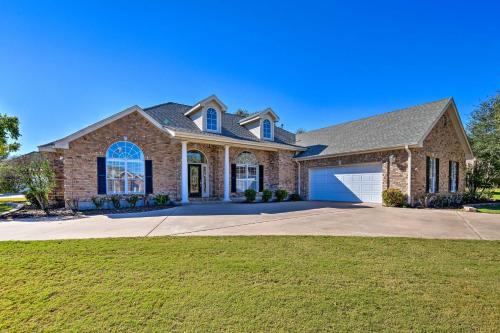 a large brick house with a garage at Abilene Home with Backyard and Grill Walk to ACU in Abilene