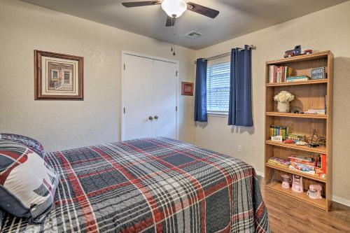 a bedroom with a bed and a book shelf at Home with Screened Porch about 10 Miles to Dtwn OKC! in Moore