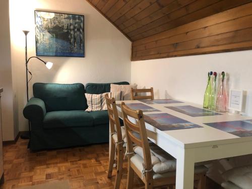a living room with a table and a couch at SavaDolinka House in Mojstrana