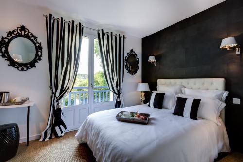 a bedroom with a large bed with a tray on it at Les Eaux qui Rient in Sanguinet