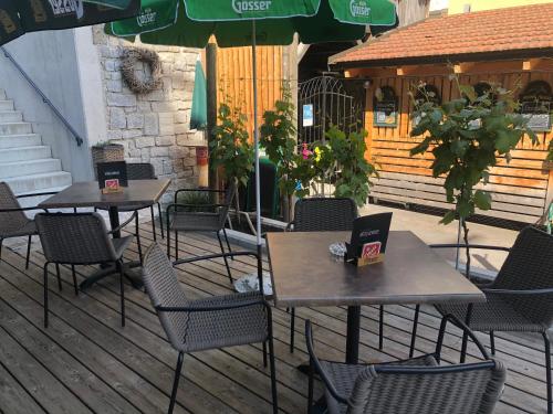 two tables and chairs with laptops on them on a patio at Hotel Donauhof Mauthausen in Mauthausen
