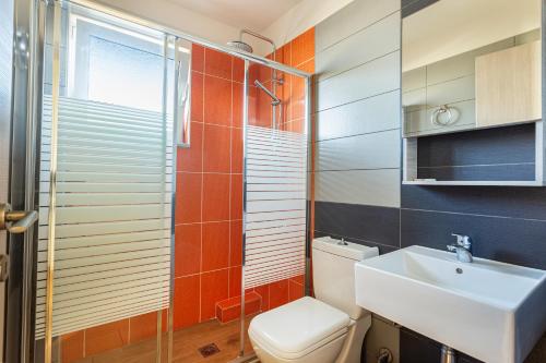 a bathroom with a toilet and a sink at Anna Αpartments II in Agia Marina Nea Kydonias