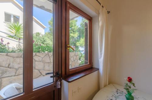 a door in a room with a window at Apartmani Srdjana in Prizba