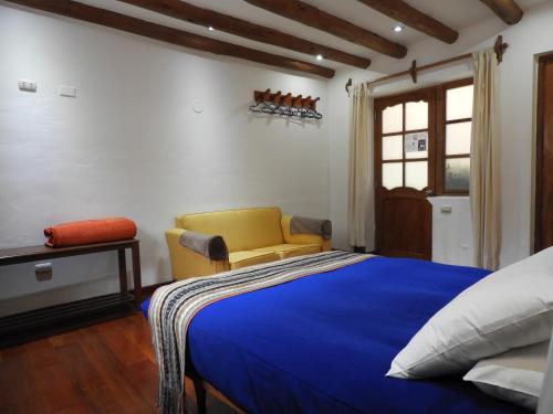 En eller flere senge i et værelse på Picaflor Tambo Guest House