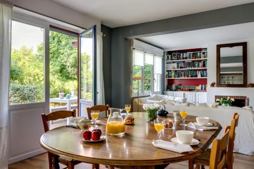 a dining room with a wooden table with fruit on it at Les Eaux qui Rient in Sanguinet