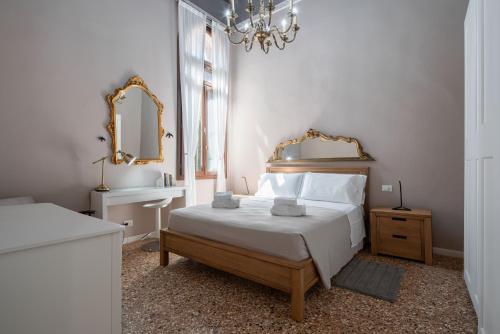 a bedroom with a bed and a mirror and a sink at Apartment Sisila in Venice