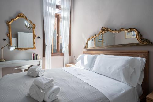 a bedroom with a white bed with towels on it at Apartment Sisila in Venice