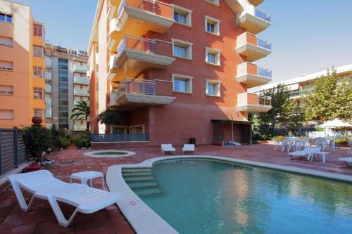 a hotel room with a pool table and chairs at Apartamentos Imperial in Salou