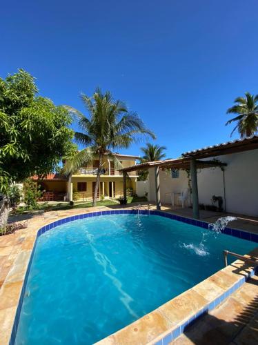 a large swimming pool in front of a house at Pousada Villa Manduca in Amontada