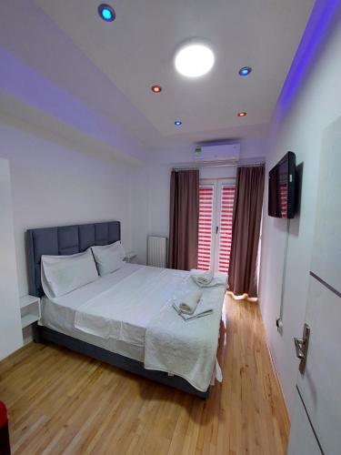 a bedroom with a large bed and a television at Petreski Apartments 1 in Ohrid