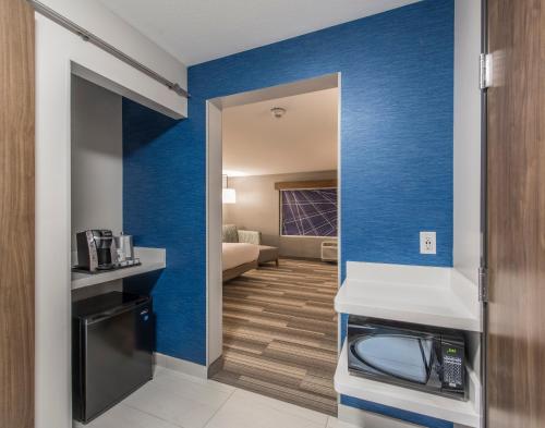 a room with a kitchen with blue walls at Holiday Inn Express & Suites - Phoenix North - Happy Valley by IHG in Phoenix
