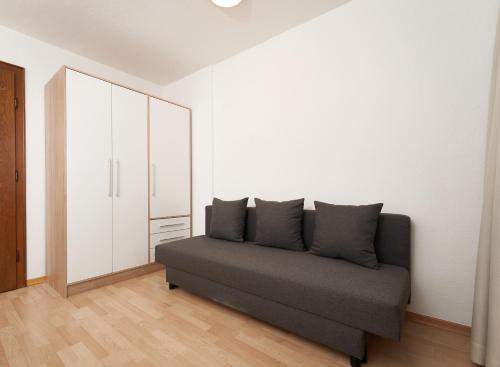 a gray couch in a room with a white wall at Gurglerhof in Sölden