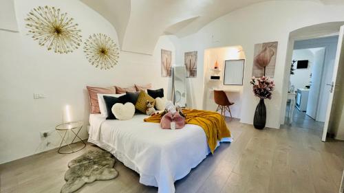 a bedroom with a bed with a pink stuffed animal on it at Le Bijou di Dolceacqua, per un momento memorabile. in Dolceacqua