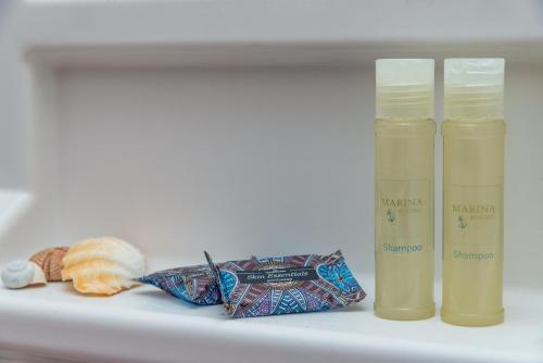 a shelf with two bottles ofodorizers and a cookie at Antoniadi Rooms in Livadia