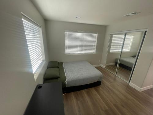 a small bedroom with a bed and a mirror at Humble Home Santa Ana 2 in Santa Ana
