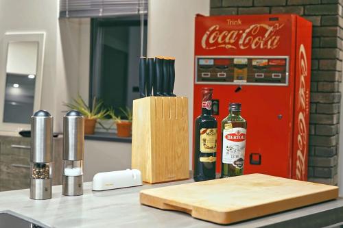 a counter with a bottle of cocacola and a bottle of alcohol at Loft mit Whirlpool Sauna Kino nähe Wolfsburg in Helmstedt