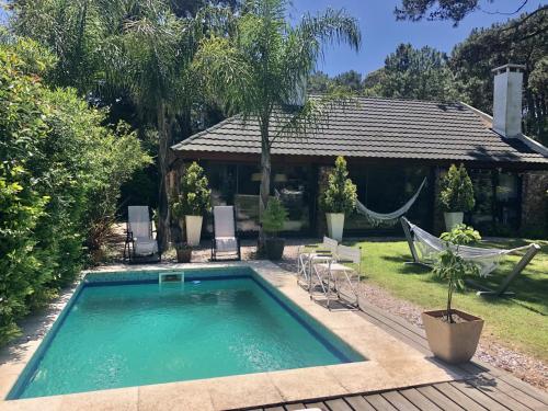 a swimming pool in the backyard of a house at Bebek B&B in Punta del Este