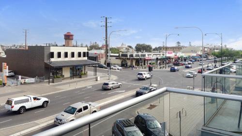 a view of a busy city street with cars on the road at Semaphore Splash Apartments in Port Adelaide
