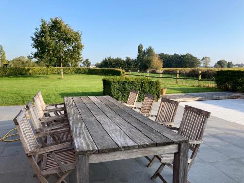 a wooden table with four chairs around it at Maison mystique in Staden