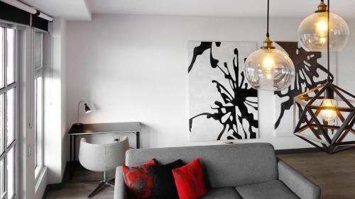a living room with a couch and a table at Semaphore Splash Apartments in Port Adelaide