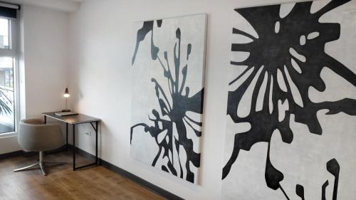 a room with a desk and a painting on the wall at Semaphore Splash Apartments in Port Adelaide