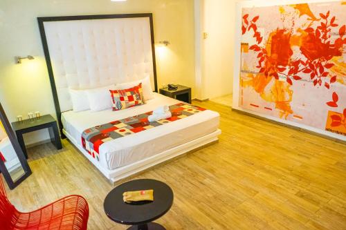 a bedroom with a large bed in a room at In Fashion Hotel & Spa in Playa del Carmen