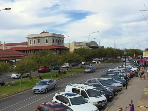 a row of cars parked in a parking lot at Semaphore Splash Apartments in Port Adelaide
