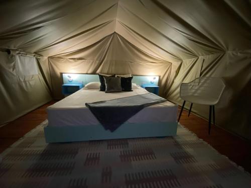 a bedroom with a bed in a tent at Hotel El Embrujo in Villa de Leyva