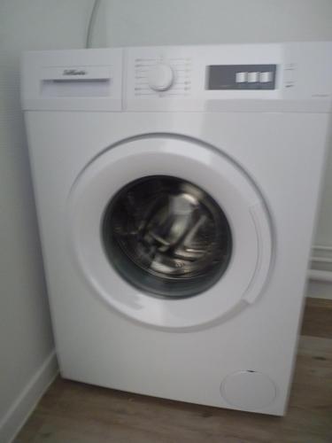 a white washing machine sitting in a room at Résidence Kerhallet in Brest