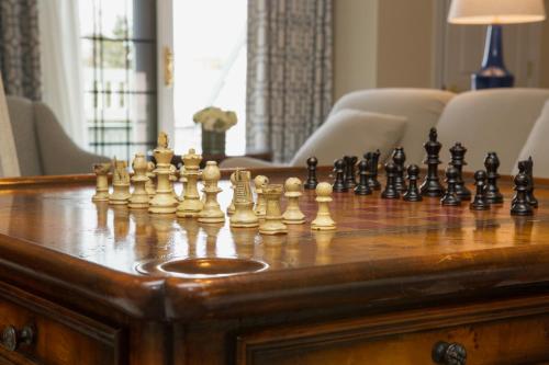 a chess set on a wooden chessboard on a table at The Bellmoor Inn and Spa in Rehoboth Beach