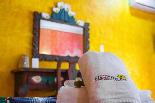 a person with their feet up in front of a television at Hacienda Maria Bonita Hotel in Playa del Carmen