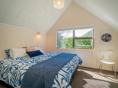 a bedroom with a bed and a window at Family Escape - Pauanui Holiday Home in Pauanui