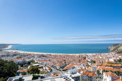 a view of a city and the ocean at Veronique Apartment in Nazaré