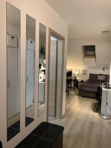 a living room with mirrors on the wall at Apartment Luna in Maribor