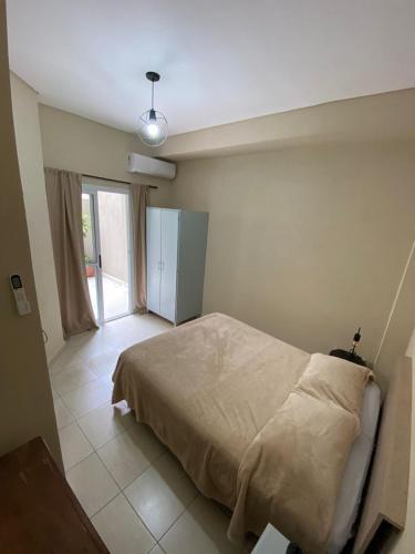 a bedroom with a bed and a large window at Costa Selva in Posadas