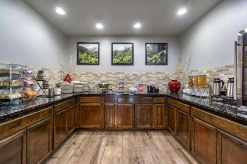 a kitchen with wooden cabinets and a counter top at Best Western PLUS Lake Front Hotel in Moses Lake