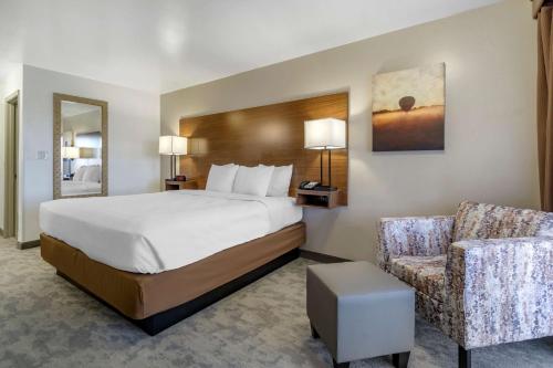 a hotel room with a bed and a chair at Best Western PLUS Lake Front Hotel in Moses Lake