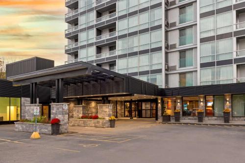 a building with a parking lot in front of it at Best Western Plus Gatineau-Ottawa Downtown in Gatineau