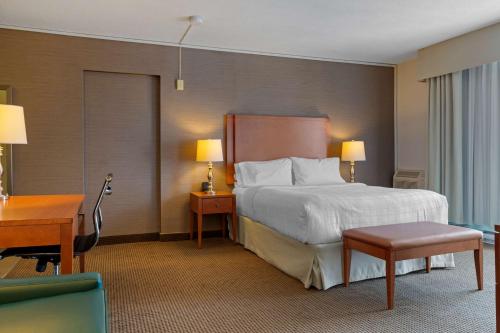 a hotel room with a large bed and a desk at Best Western Plus Gatineau-Ottawa Downtown in Gatineau