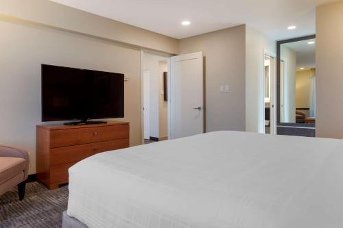 a bedroom with a bed and a flat screen tv at Best Western Plus Gatineau-Ottawa Downtown in Gatineau